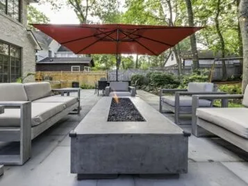 PetrovicImagery_Apex_Asbury-15 Modern outdoor lounge seating around a linear concrete fire table — Apex Landscaping