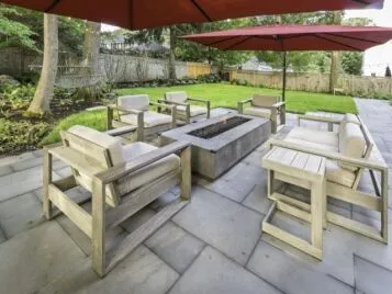 PetrovicImagery_Apex_Asbury-8 Paver patio with modern outdoor seating and a fire table — Apex Landscaping