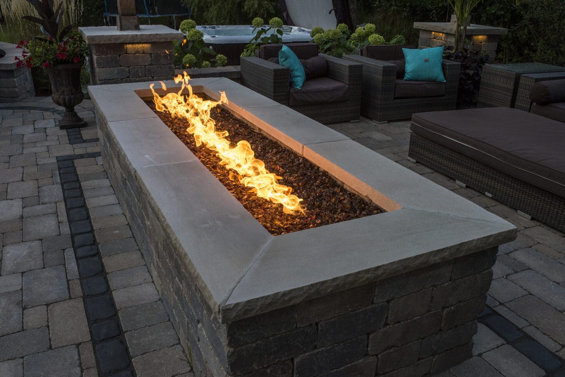 Linear fire feature with outdoor lounge seating — Apex Landscaping design-build