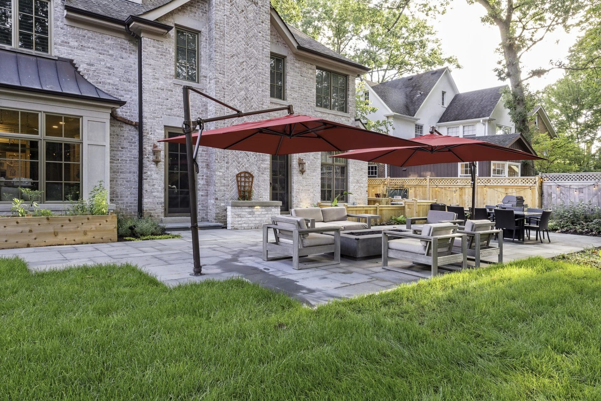 Outdoor patio sectional with market umbrellas — Apex Landscaping