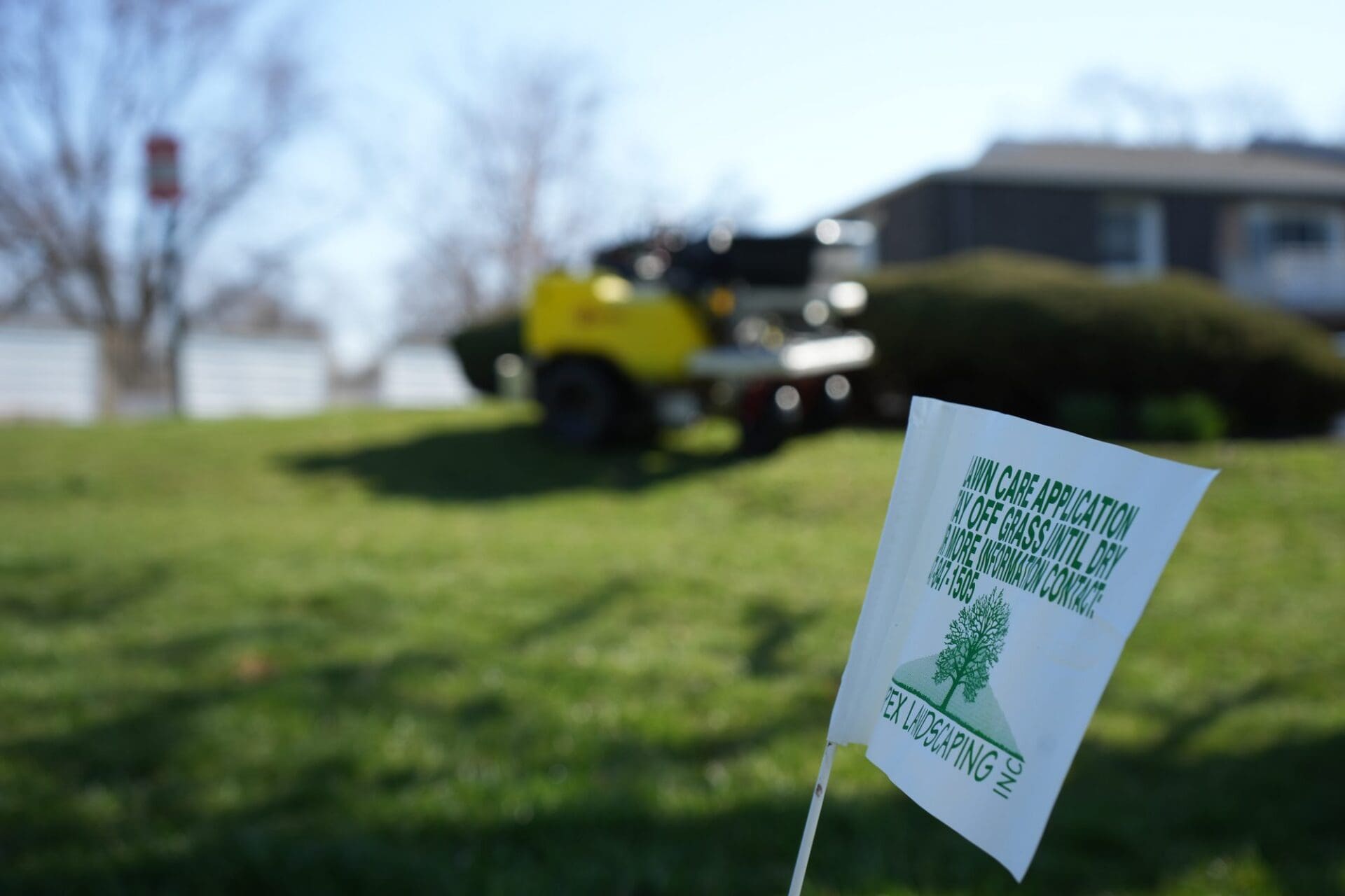 Apex Landscaping lawn care application flag on a treated lawn