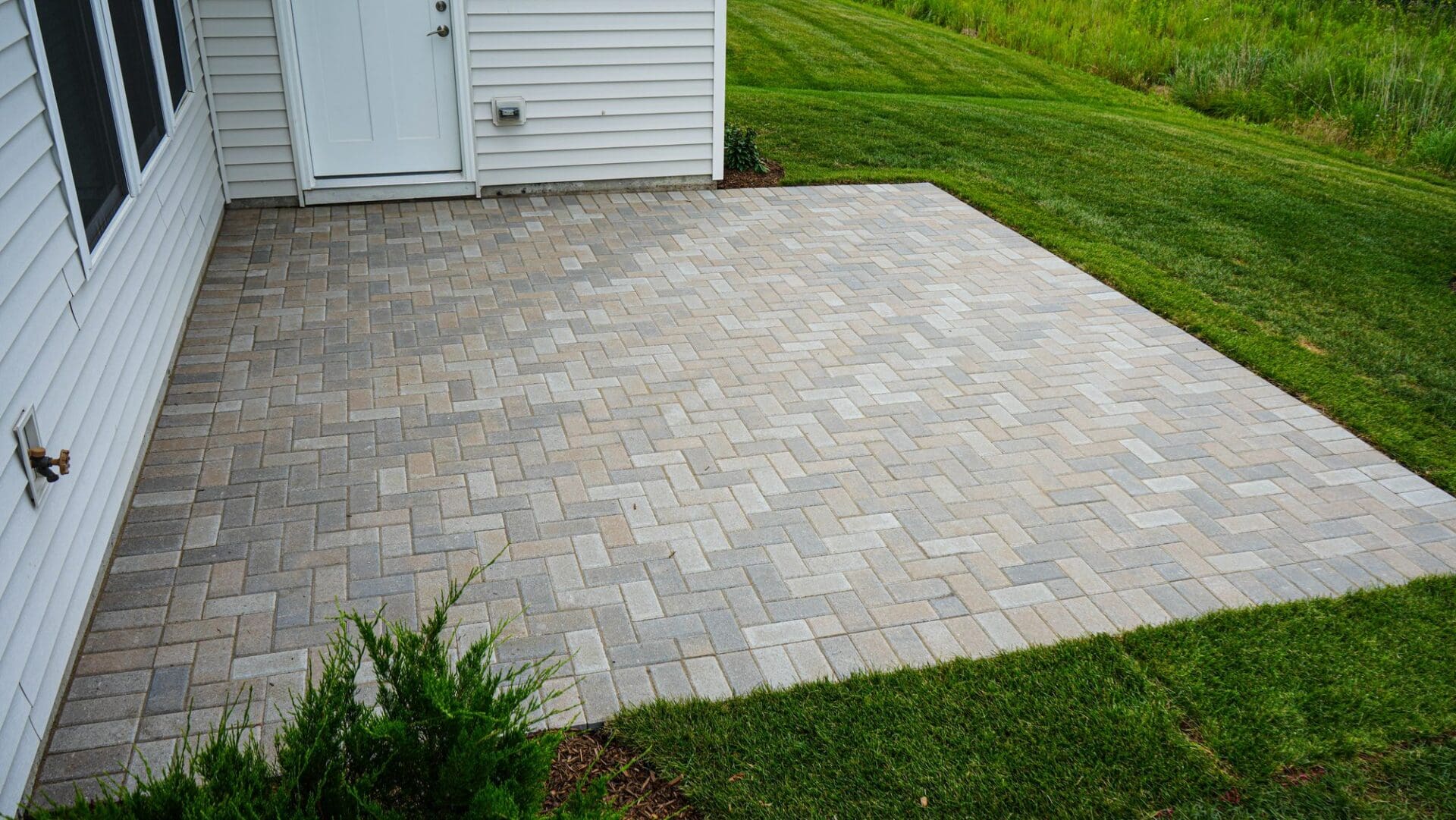 Finished herringbone paver patio — Apex Landscaping design-build