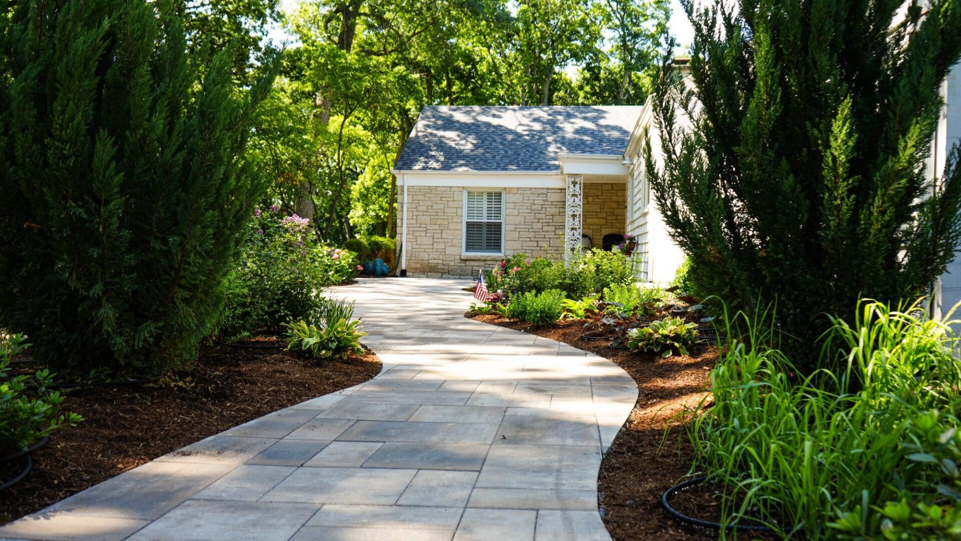 Finished curving paver walkway and landscaped front yard — Apex Landscaping