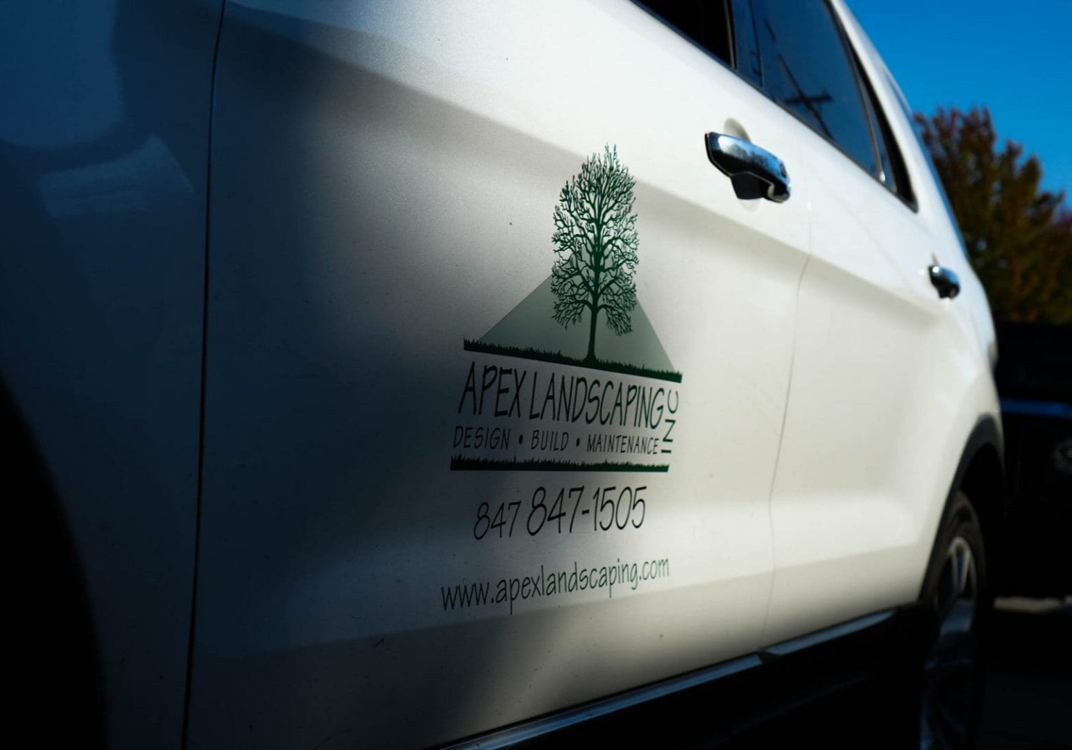 Apex Landscaping branded work truck at a tree-care job